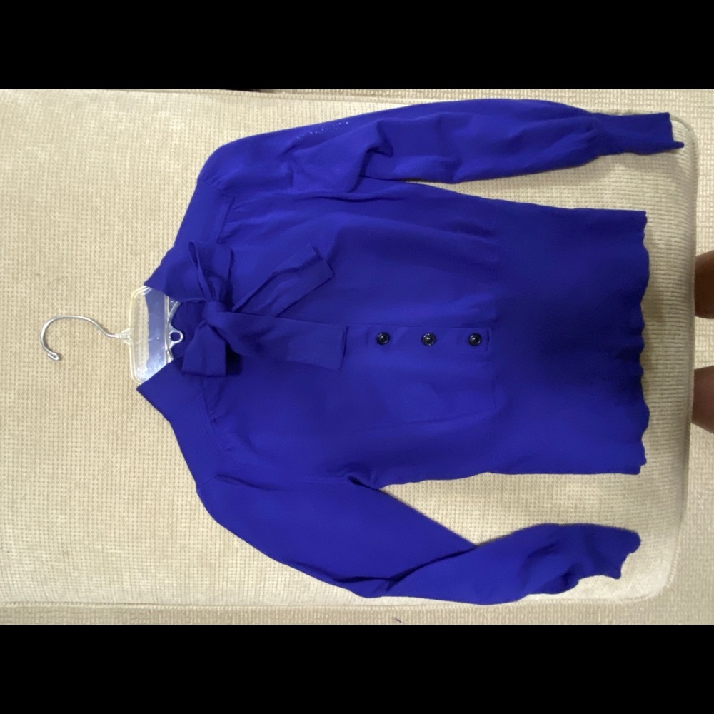 Periwinkle blue tie neck sweater.